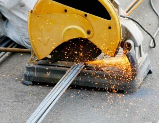 Heavy-duty chop saw cutting rebar efficiently on a construction project