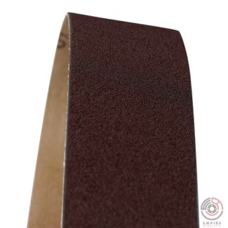 Close-up view of a 2" x 72" aluminum oxide sanding belt with a brown X-weight cloth backing. This commonly used belt is ideal for metalworking, woodworking, and construction applications due to the X-weight cloth backing's durability and flexibility.