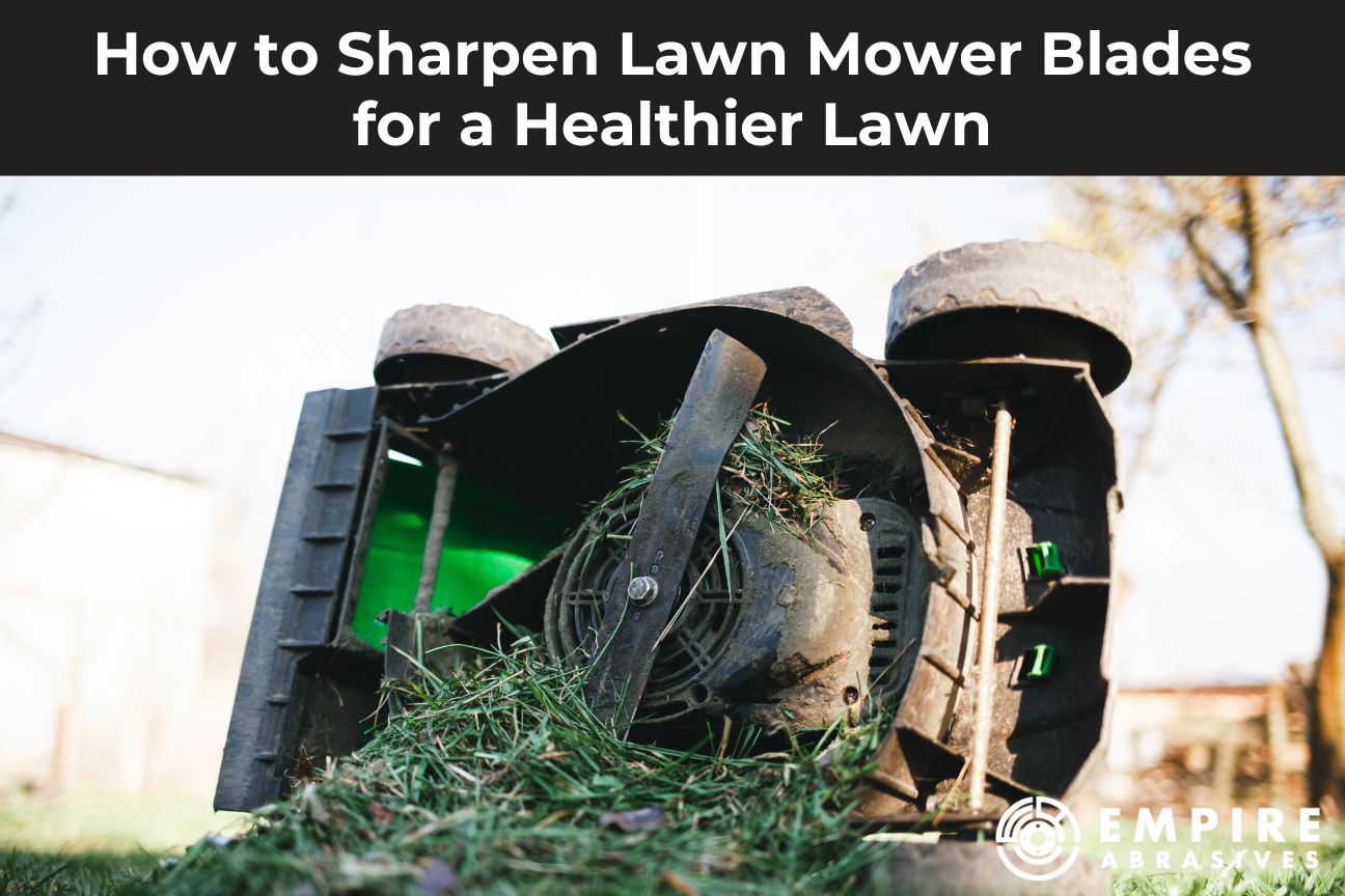 Upside-down lawn mower showing a grass-clogged blade, illustrating how to sharpen lawn mower blades for a cleaner, healthier lawn