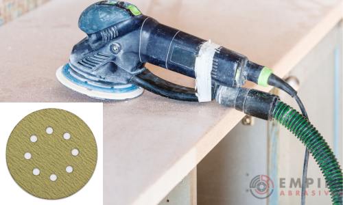 Random Orbital Sander with vacuum dust collection system connected, shown with a gold aluminum oxide sanding disc with holes, perfect for efficient hardwood tabletop finishing and preparation for painting