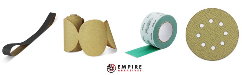 Assorted sanding products from Empire Abrasives including a sanding belt, gold PSA sanding disc roll, a green longboard sandpaper roll, and a gold hook and loop sanding disc, representing the variety of abrasives for sanding applications