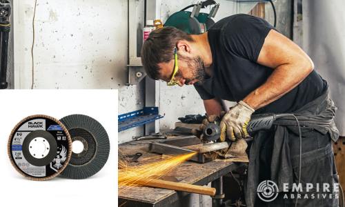 Skilled welder preparing steel for welding using an angle grinder equipped with a T29 zirconia flap disc, providing efficient weld prep by smoothing out steel surface imperfections